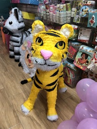 a tiger and zebra pinata in a store