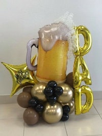 a balloon arrangement with a beer mug and balloons