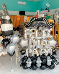 a balloon display with a mustache and a bottle of champagne