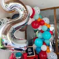 a balloon arch decorated for a second birthday party