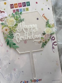 a cake topper with the word happy birthday on it