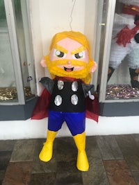 a thor costume standing in front of a store