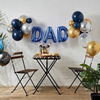 a table with chairs and a table with the word dad on it