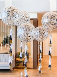 confetti balloons with gold and black tassels