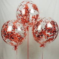 three red and white confetti confetti balloons