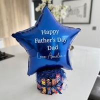 a blue star shaped balloon with the words happy father's day dad