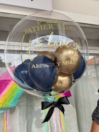 a man is holding a balloon that says father's day